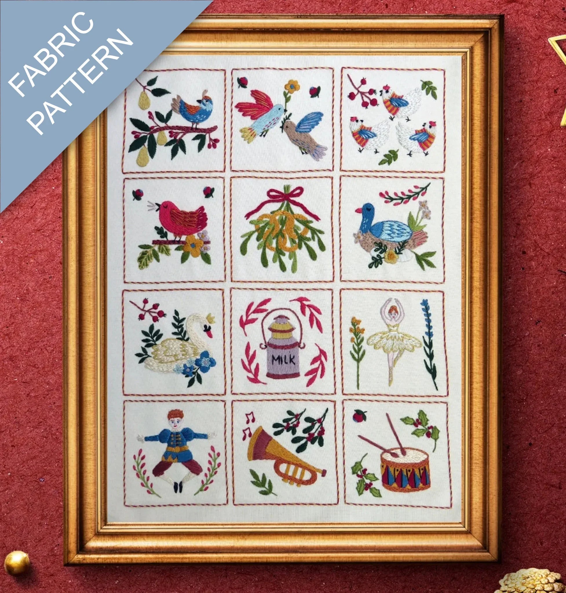 Framed fabric pattern with embroidered designs on a red background