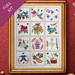Framed cross-stitched sampler with various designs on a red background