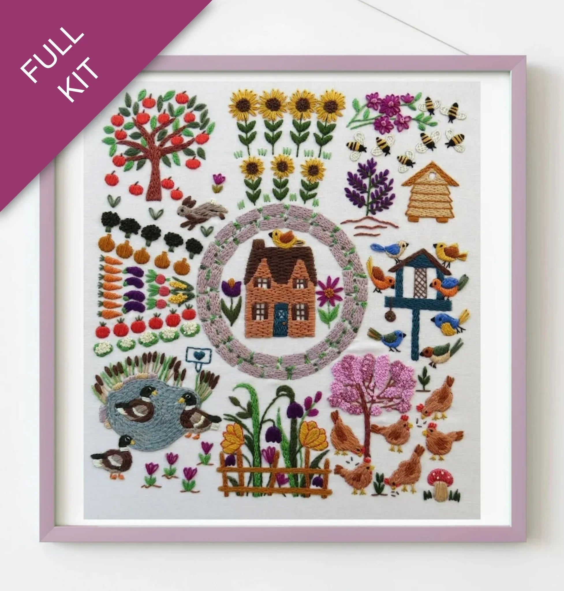 Embroidery kit with a garden scene including flowers, trees, and animals on a white background.