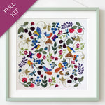 Framed embroidered artwork with colorful birds and flowers on a white background
