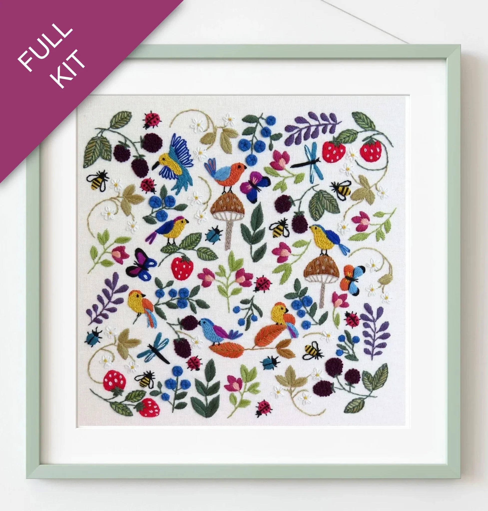 Framed embroidered artwork with colorful birds and flowers on a white background