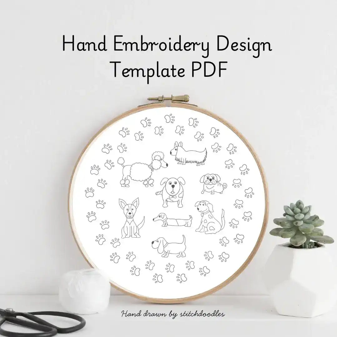 Hand embroidery design template with dogs and paw prints in an embroidery hoop on a white background.