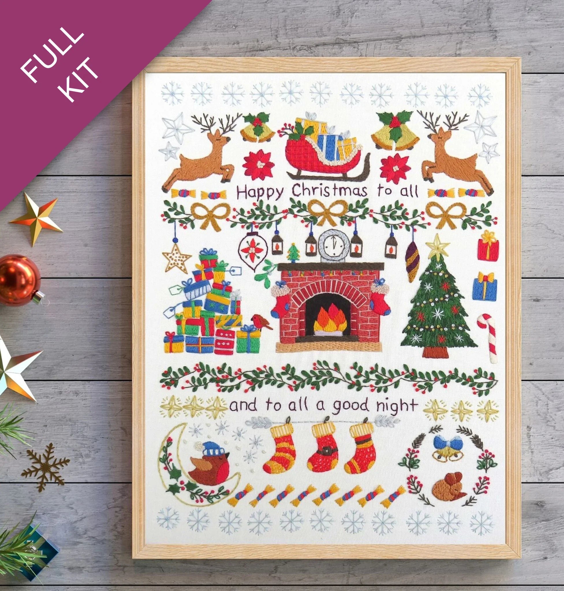 Framed Christmas-themed print with festive illustrations on a wooden surface.