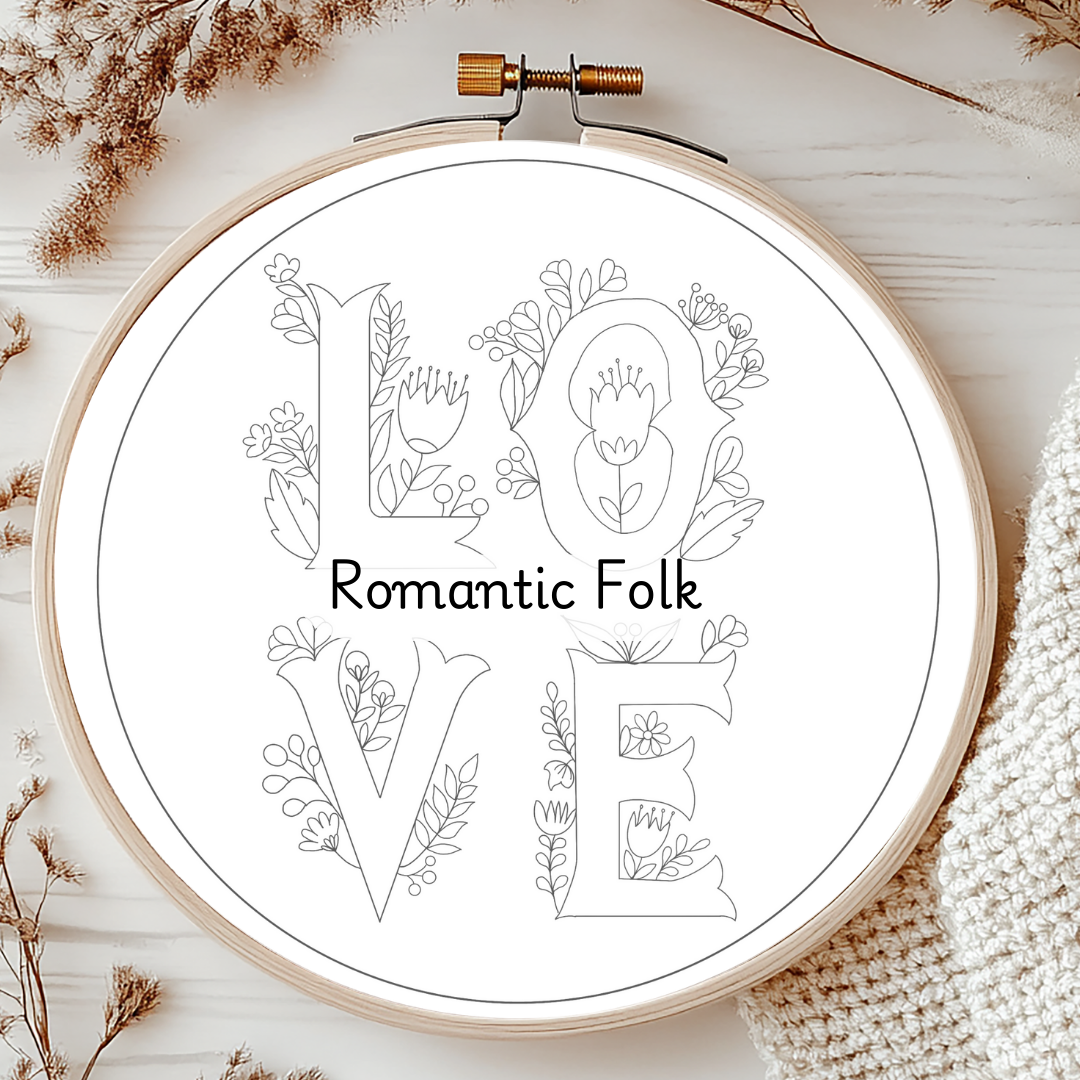 Embroidery hoop with 'Romantic Folk' text and floral designs on a wooden surface.