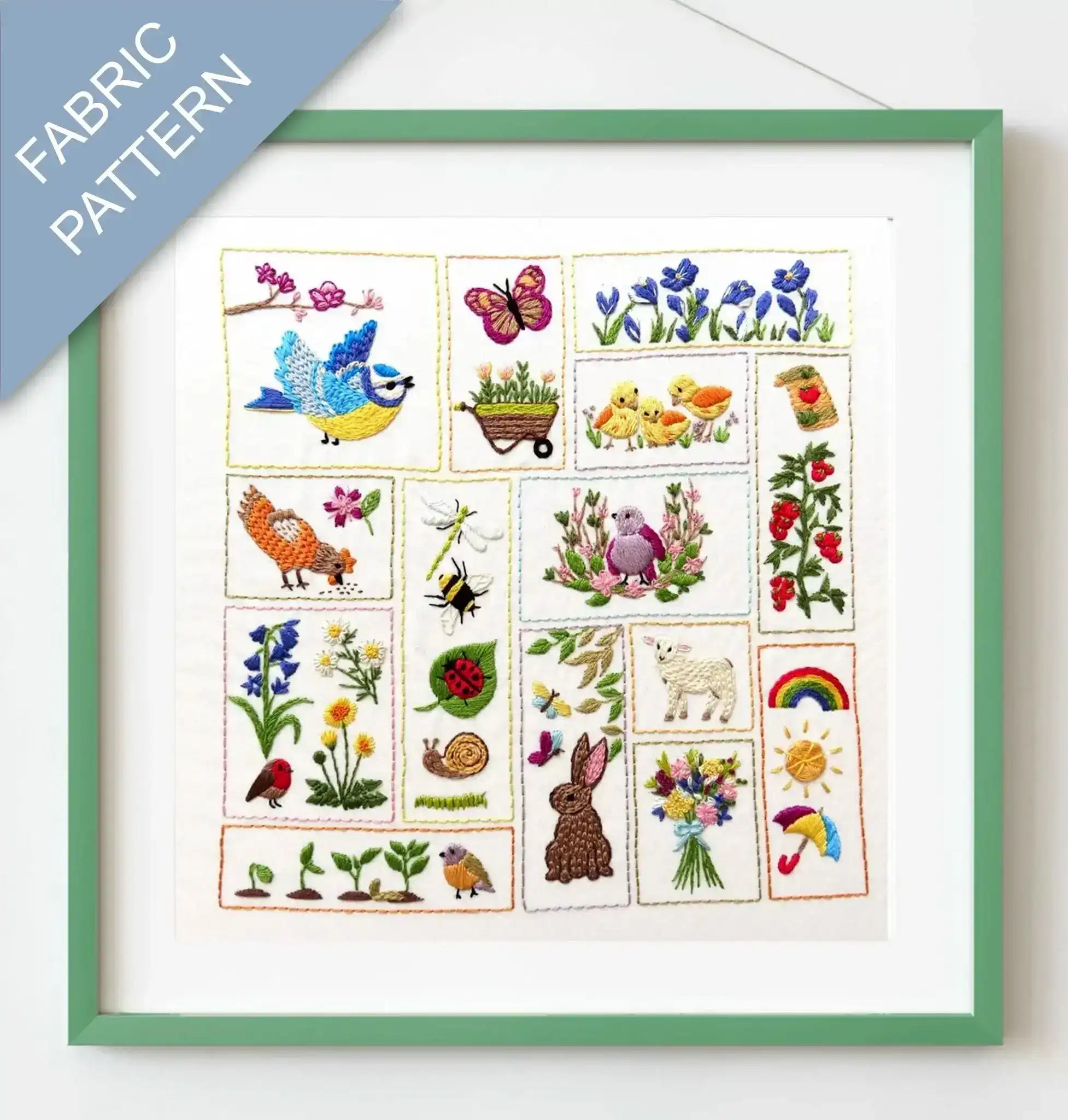 Framed fabric pattern with embroidered designs of animals, plants, and nature-themed elements.