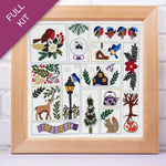 Framed cross-stitch kit with various designs including birds, flowers, and animals on a white background.