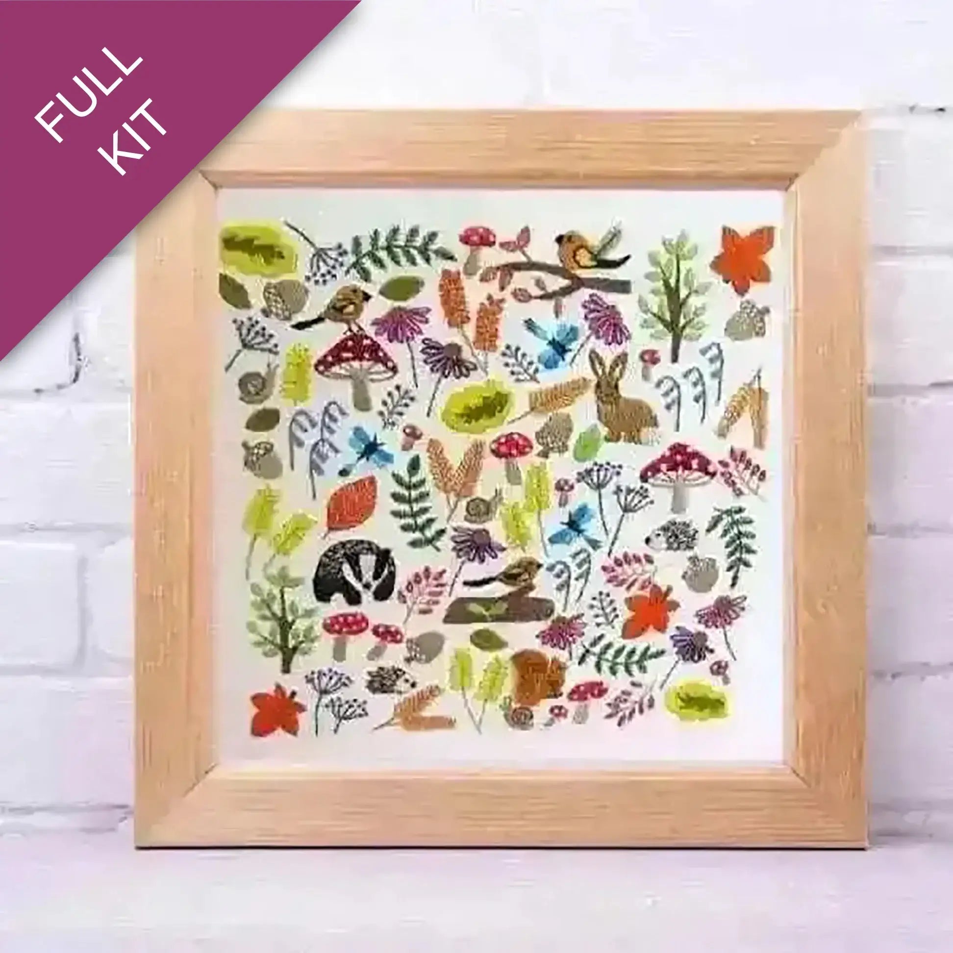Framed artwork with nature-themed designs on a white brick wall background
