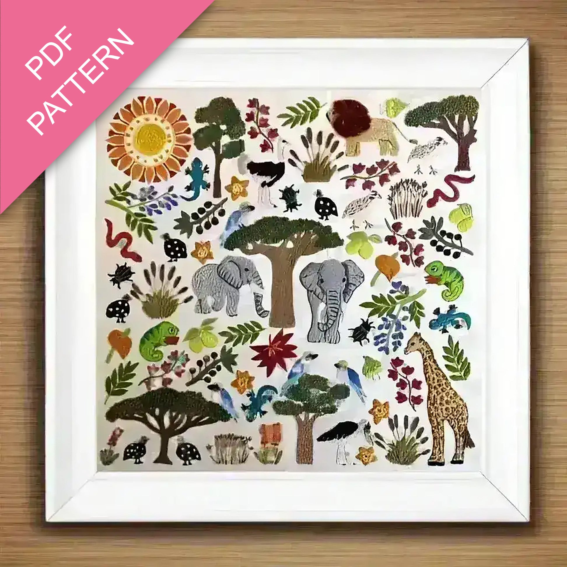 Framed PDF pattern with colorful animal and nature illustrations on a wooden surface.