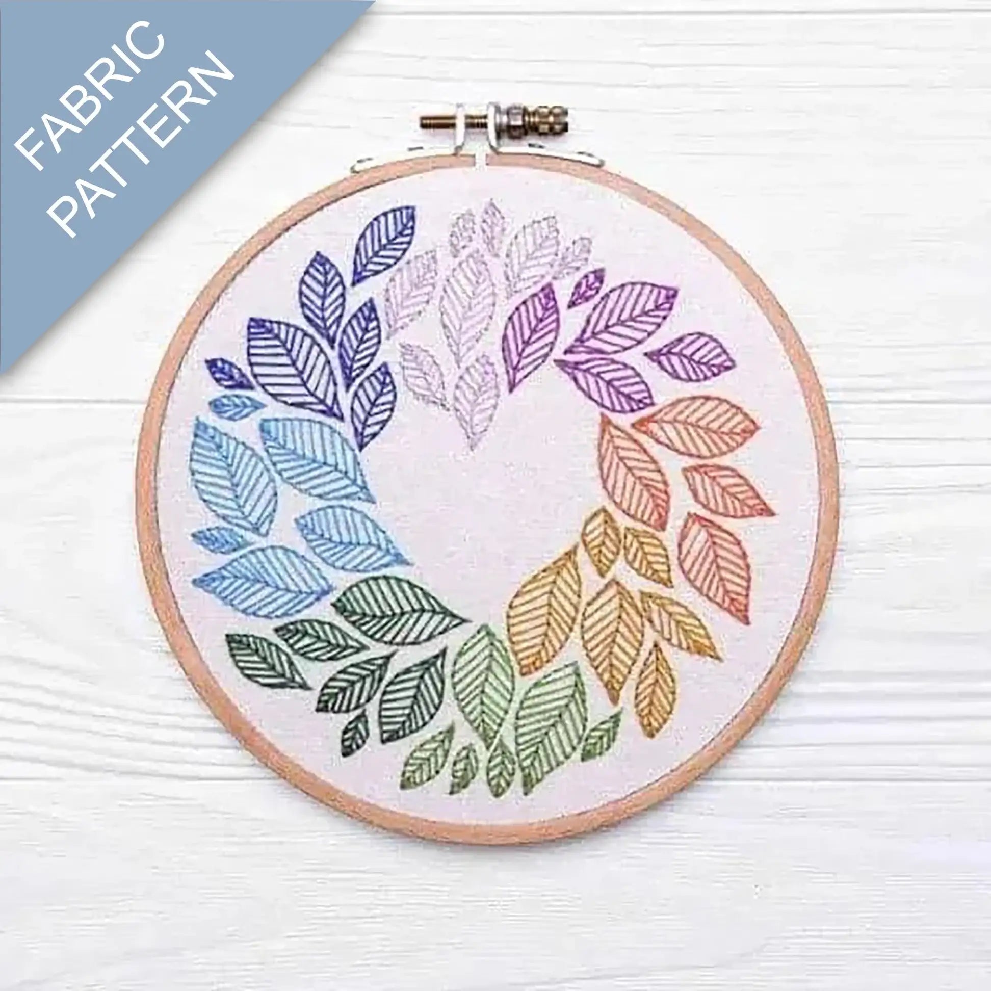 Embroidery hoop with colorful leaf pattern on fabric, labeled 'Fabric Pattern'.