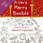 Hand embroidery advent calendar with Christmas-themed designs and text 'A Very Merry Bauble'.