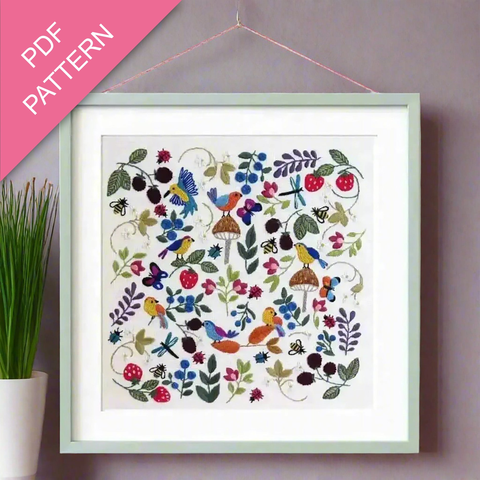 Framed embroidered artwork with birds and flowers on a wall, labeled 'PDF Pattern'.