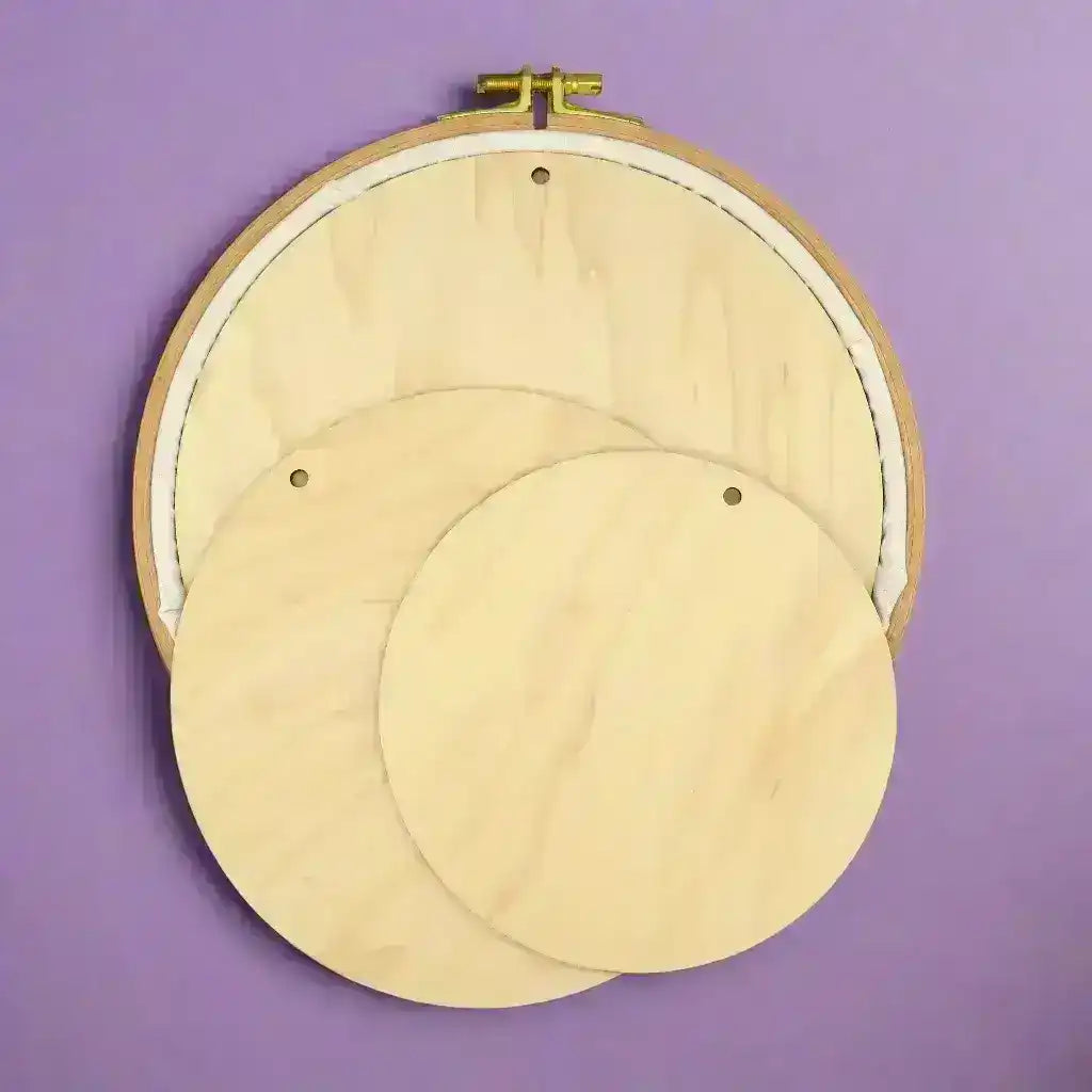 Wooden embroidery hoops on a purple background