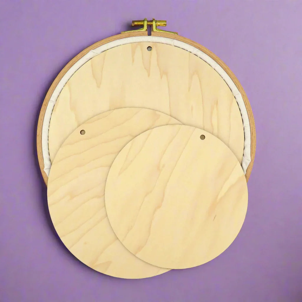 Wooden embroidery hoops on a purple background