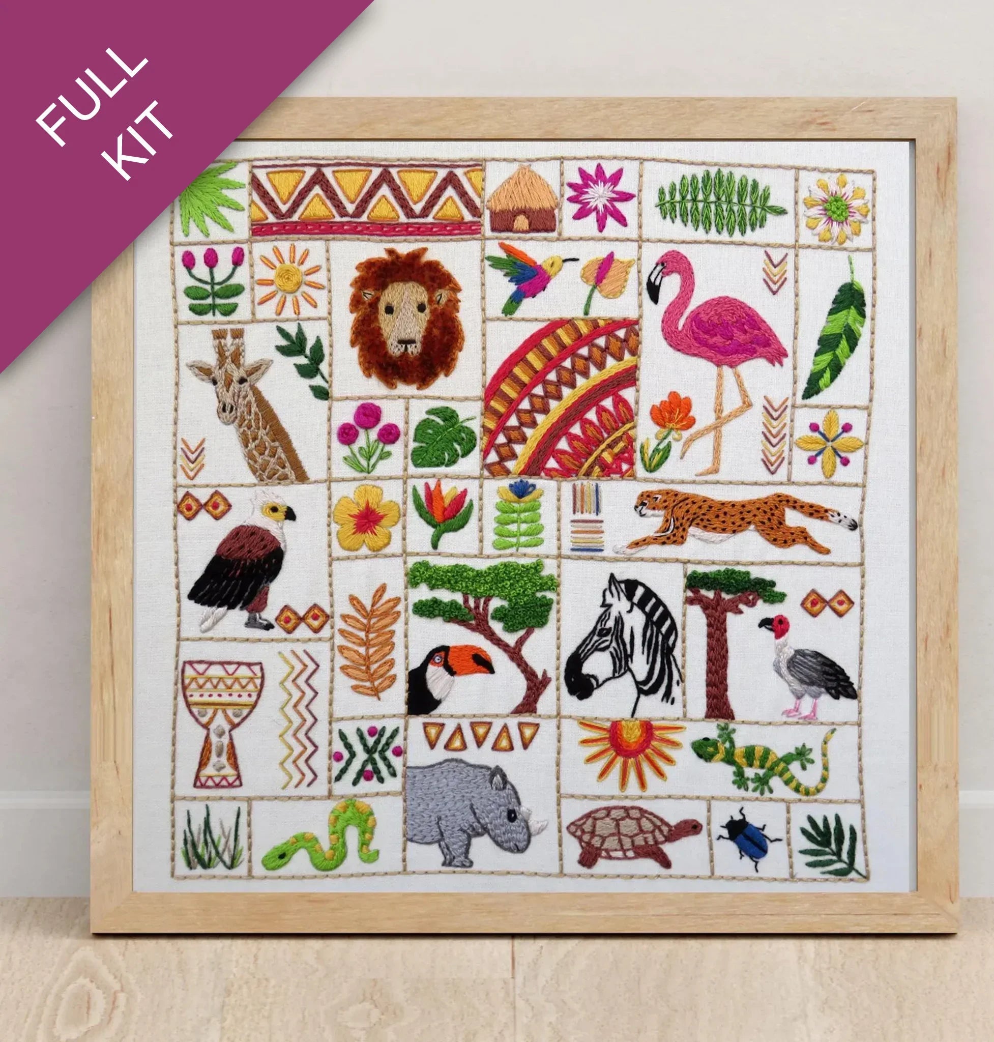 Embroidery kit with pre-designed pattern of animals and plants on a white fabric background.