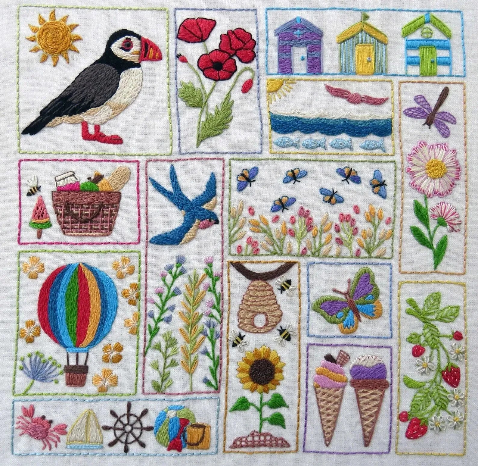 Embroidered patchwork design with various elements including a puffin, flowers, boats, and ice cream cones.