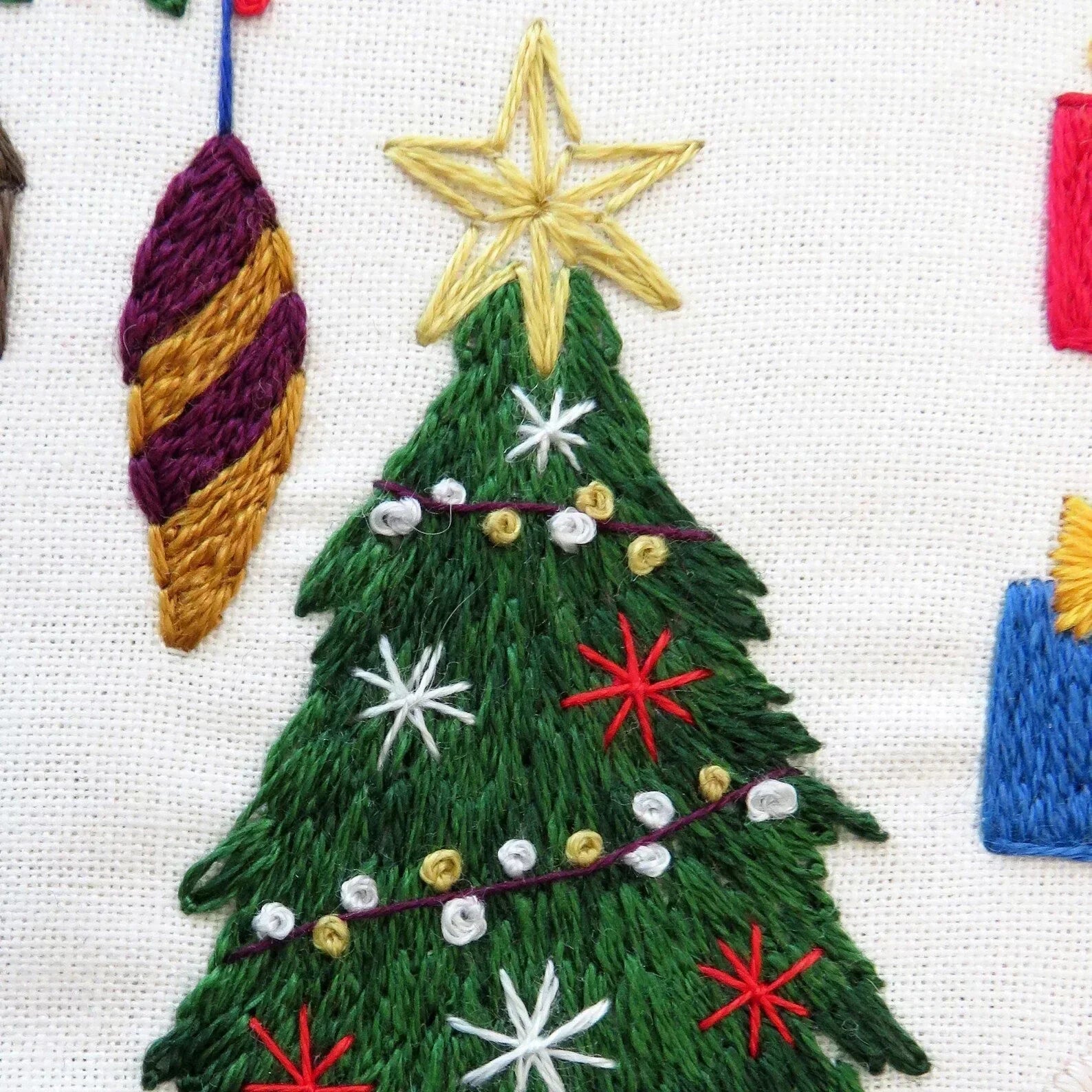 Embroidered Christmas tree with decorations on a white background