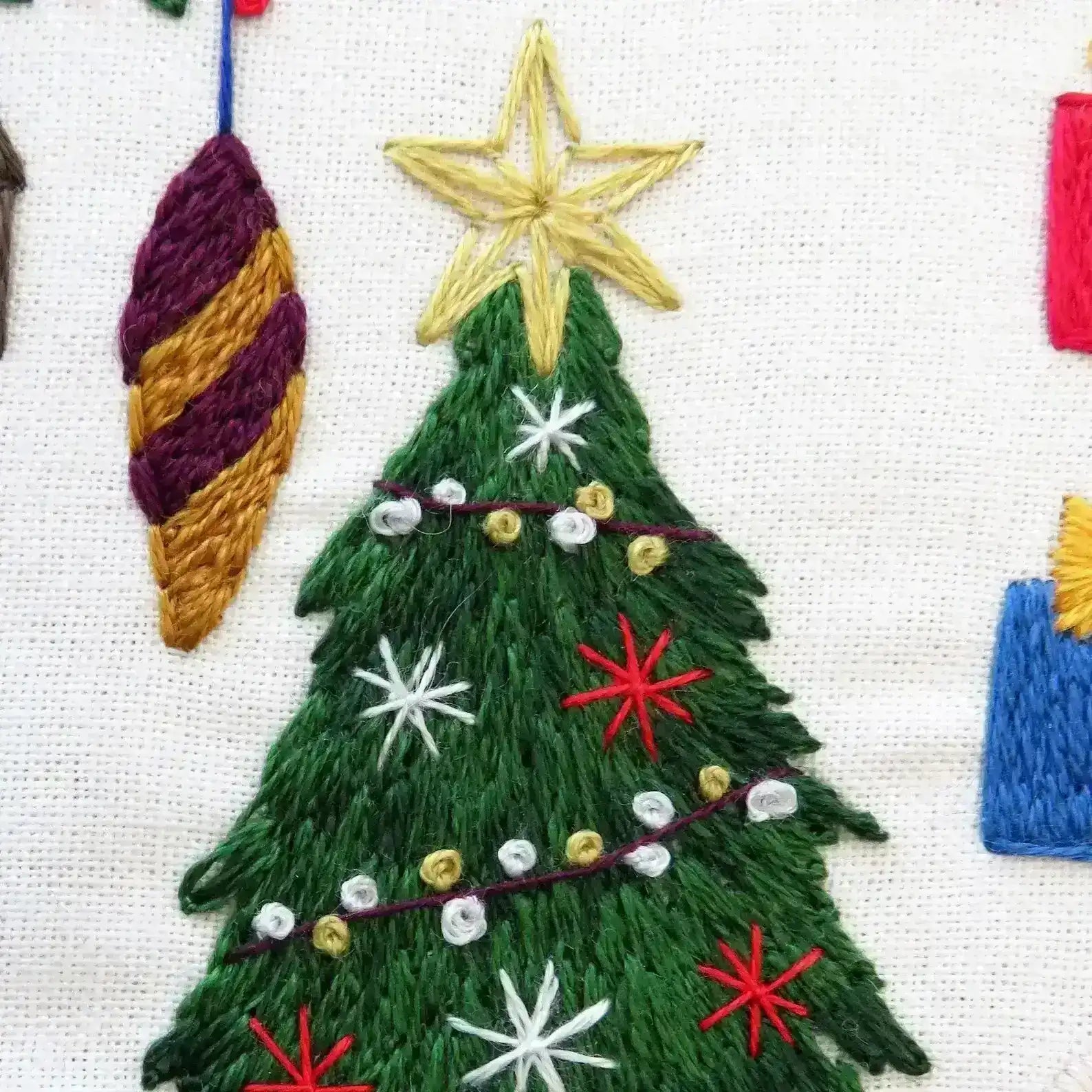 Embroidered Christmas tree with decorations on a white background