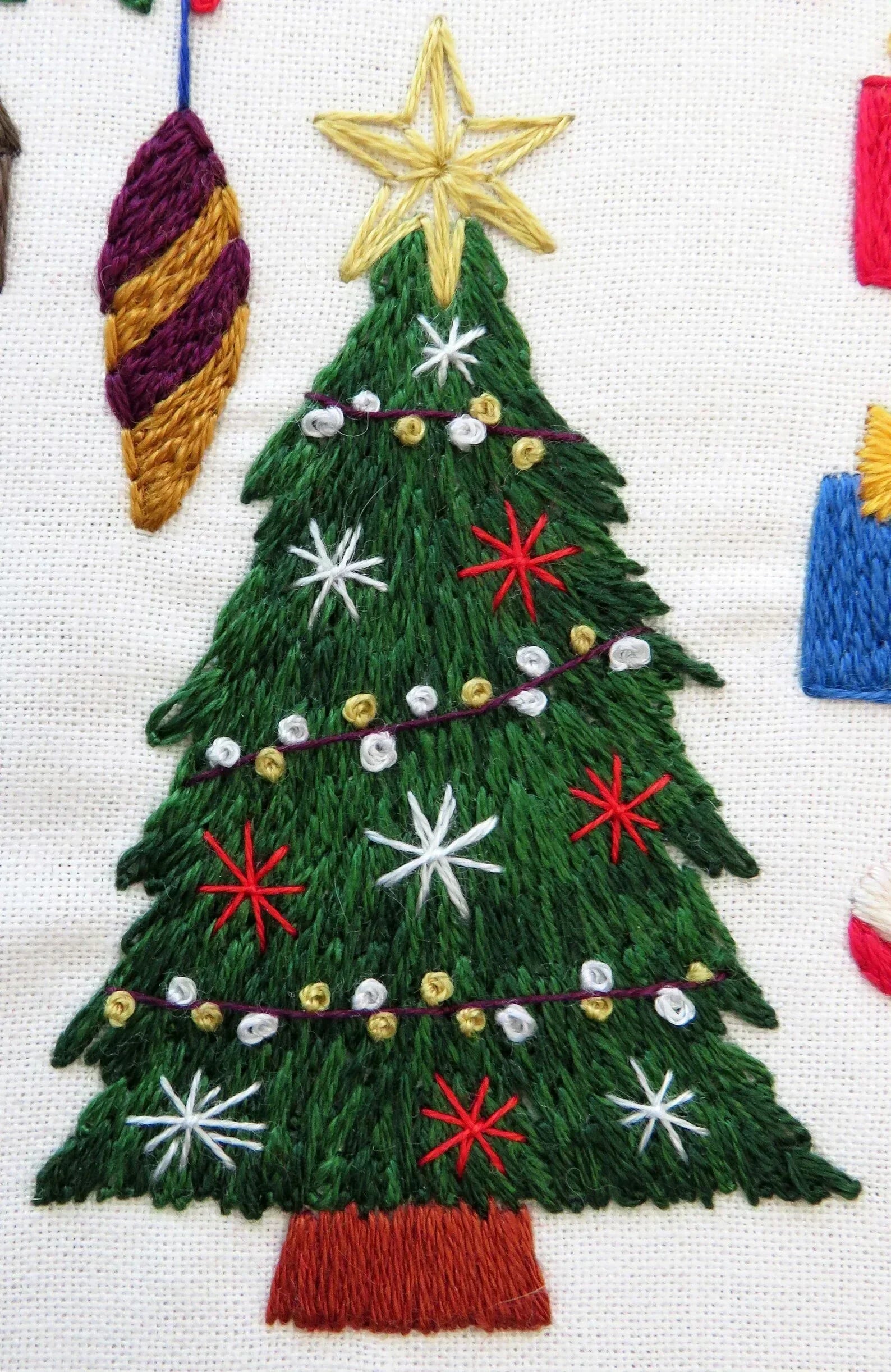 Embroidered Christmas tree with decorations on a white background