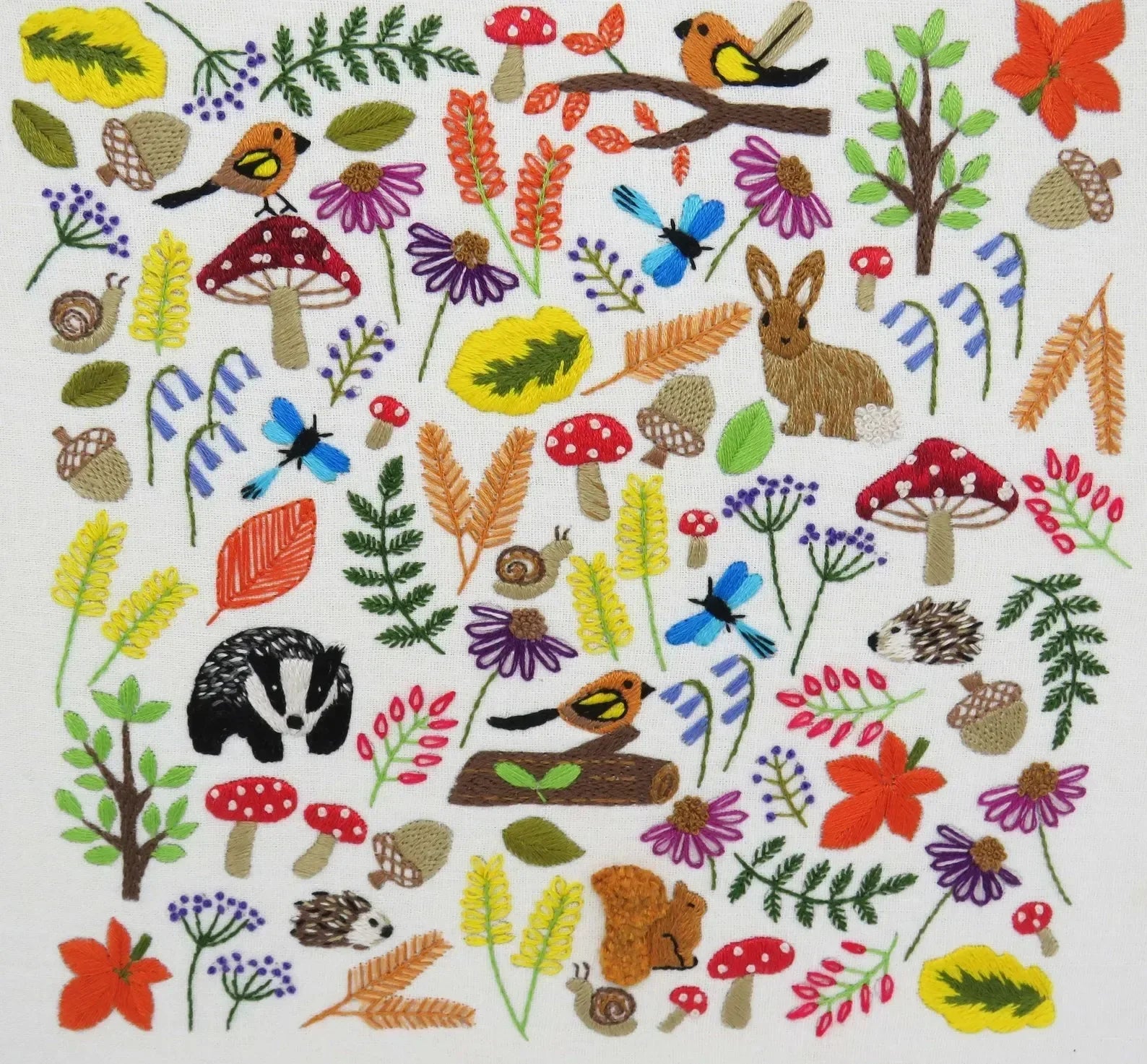 Colorful pattern of forest animals and plants on a white background