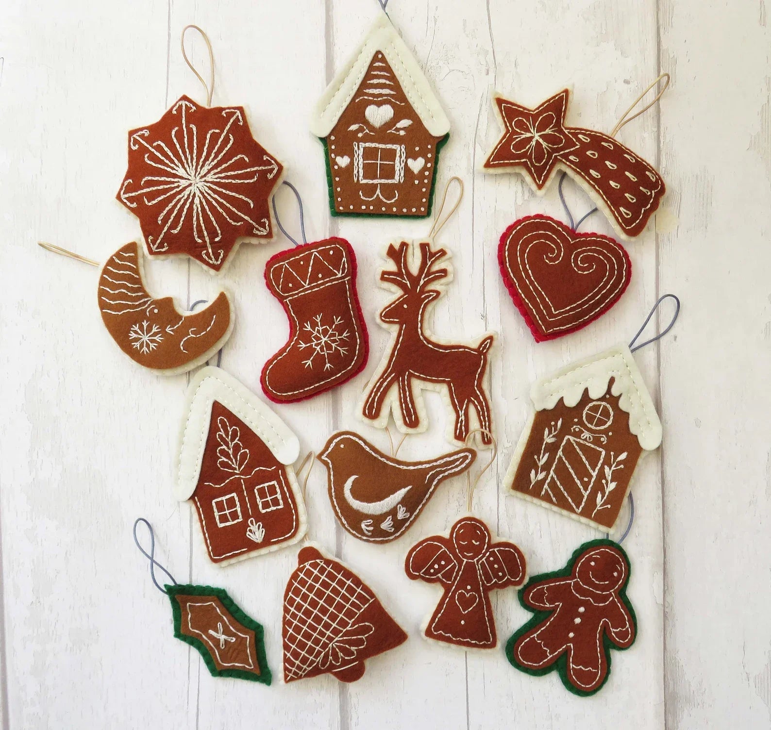 Set of Christmas-themed gingerbread cookie decorations on a white wooden background