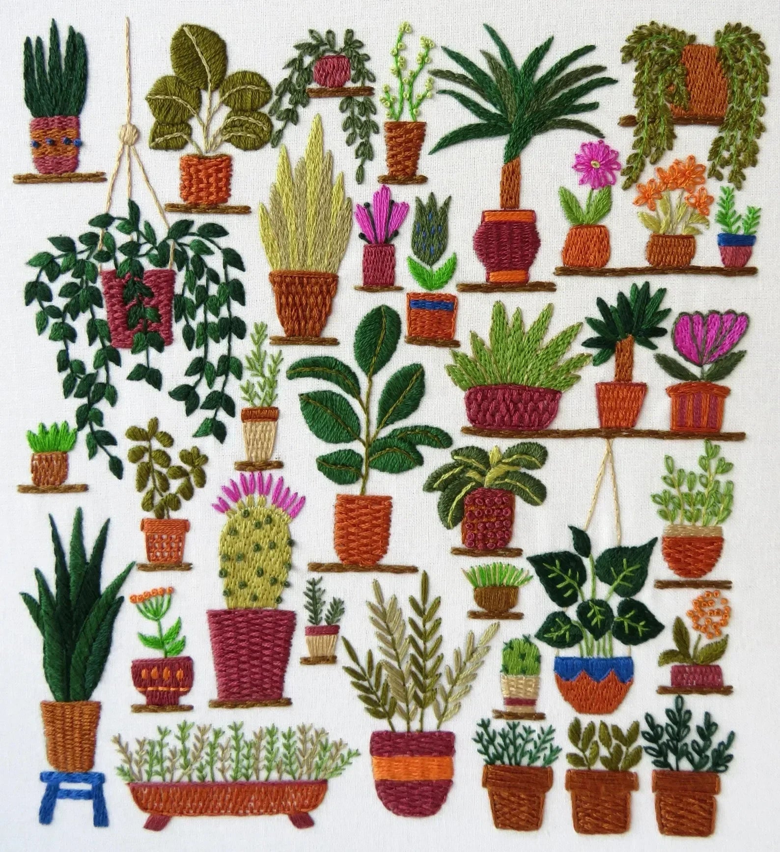 Embroidered pattern of various potted plants on a white background