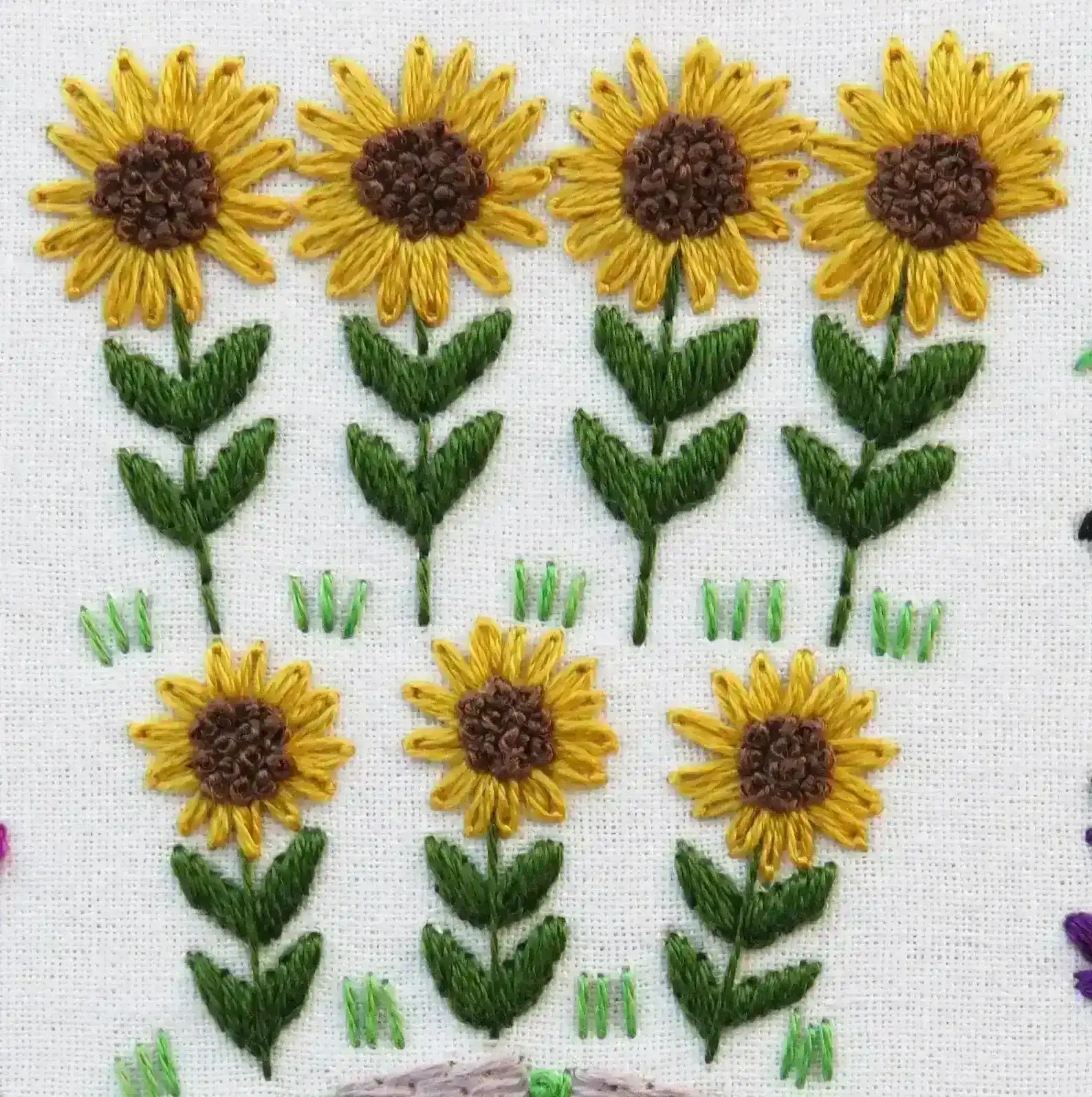 Embroidered pattern of sunflowers on a white background