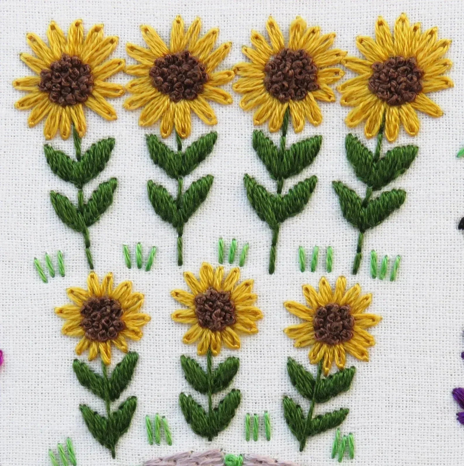 Embroidered pattern of sunflowers on a white background