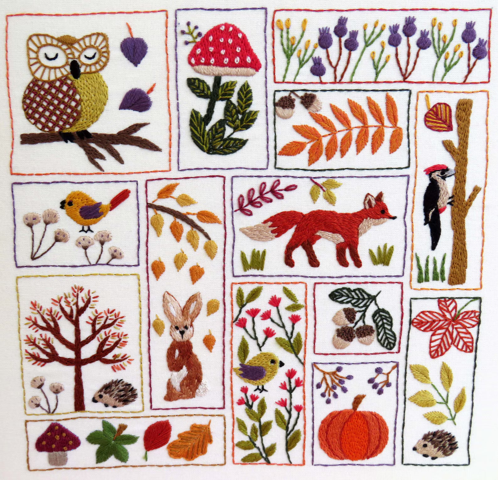 Embroidered patchwork design with nature-themed elements including animals, plants, and trees.