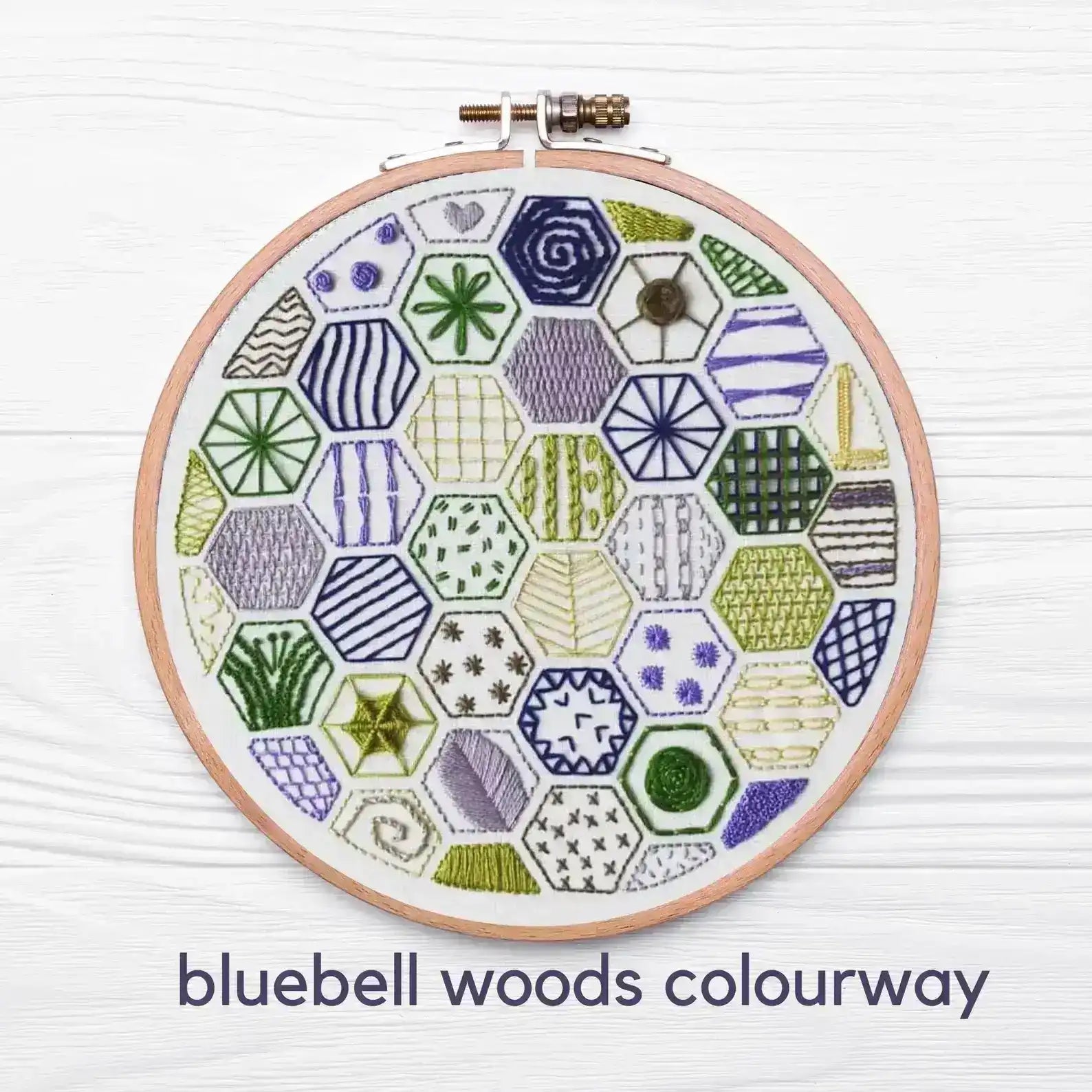 Embroidery hoop with geometric pattern on a white background, labeled 'bluebell woods colourway'.