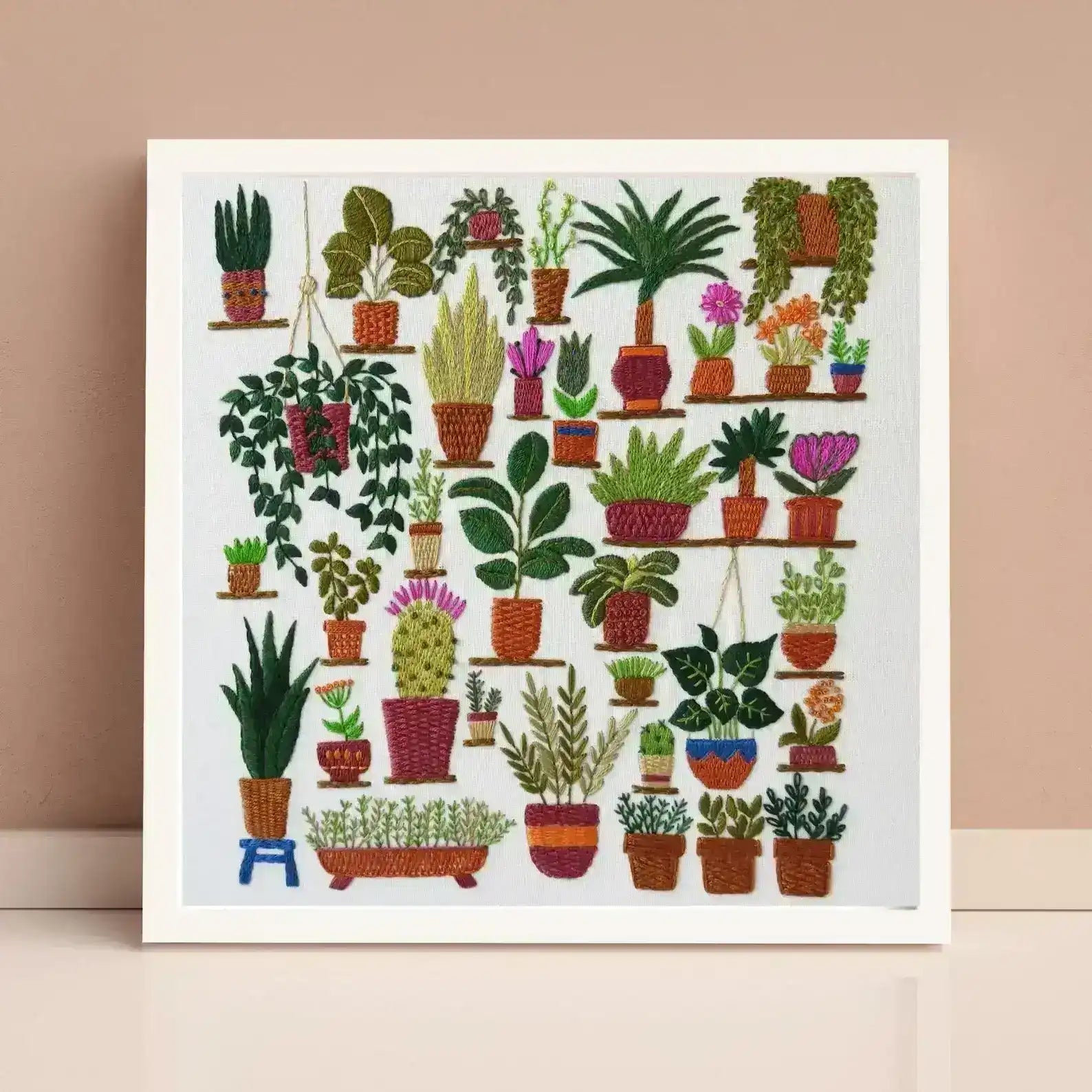 Framed artwork of various potted plants on a beige background