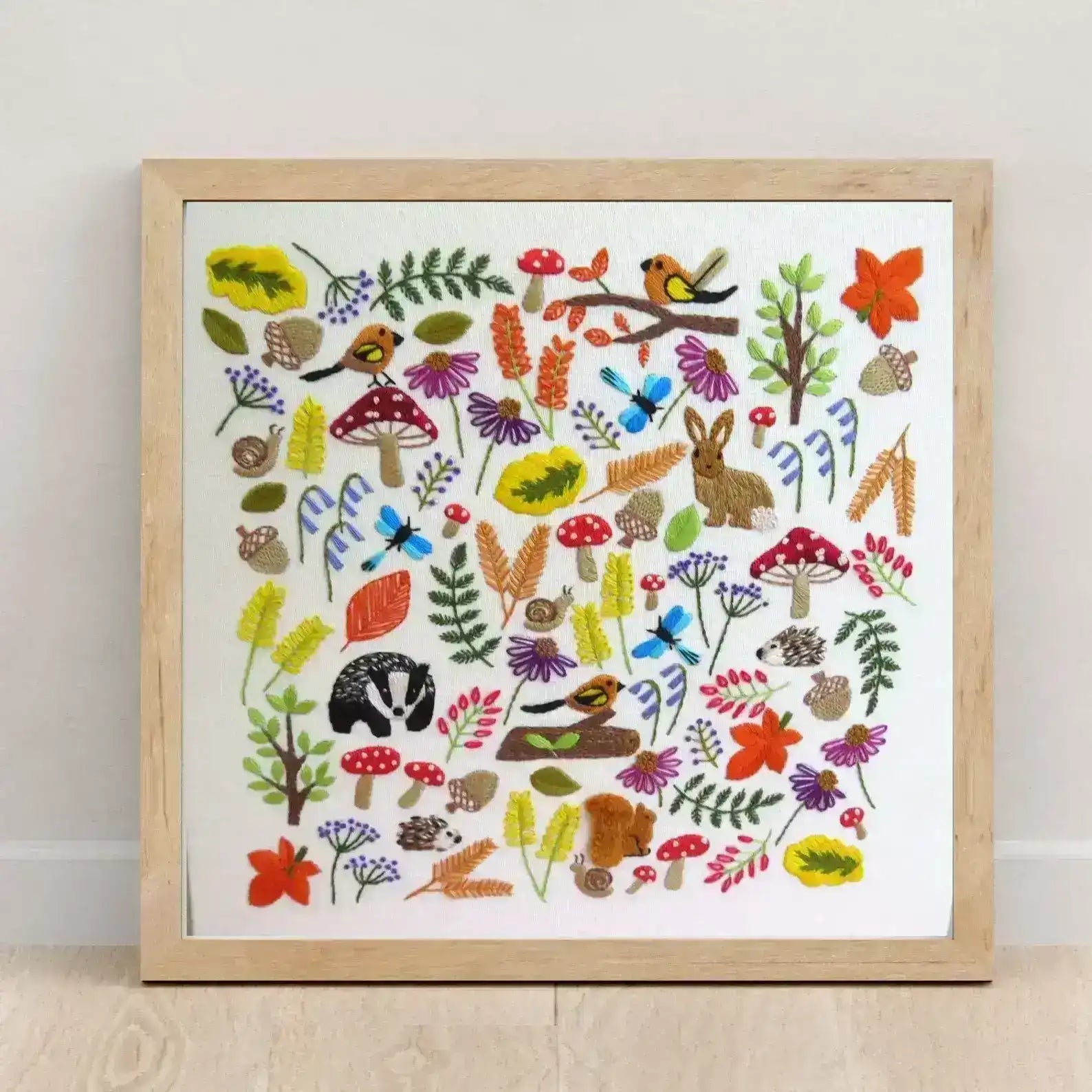 Framed artwork with colorful illustrations of nature elements on a white background