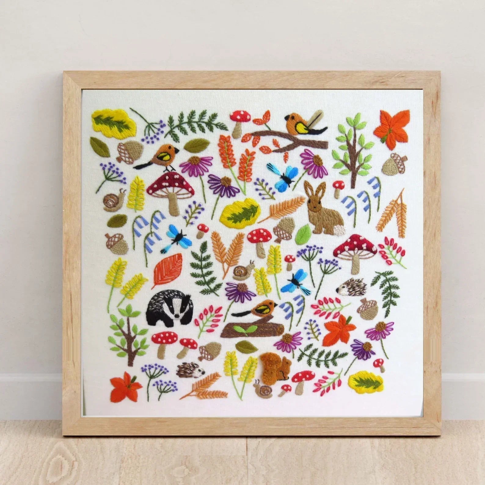 Framed artwork with colorful illustrations of nature elements on a white background