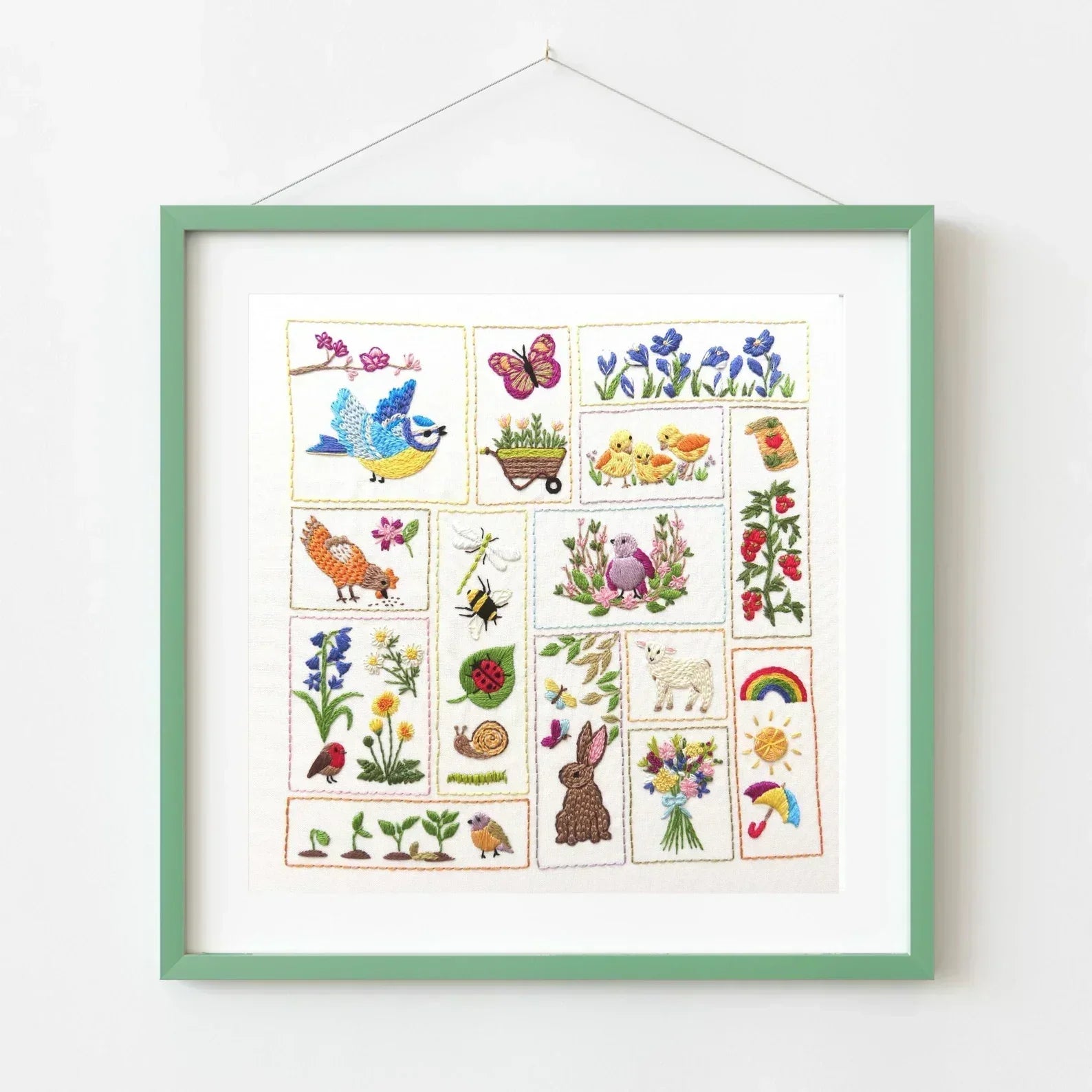 Framed artwork with illustrations of animals, plants, and nature on a white background