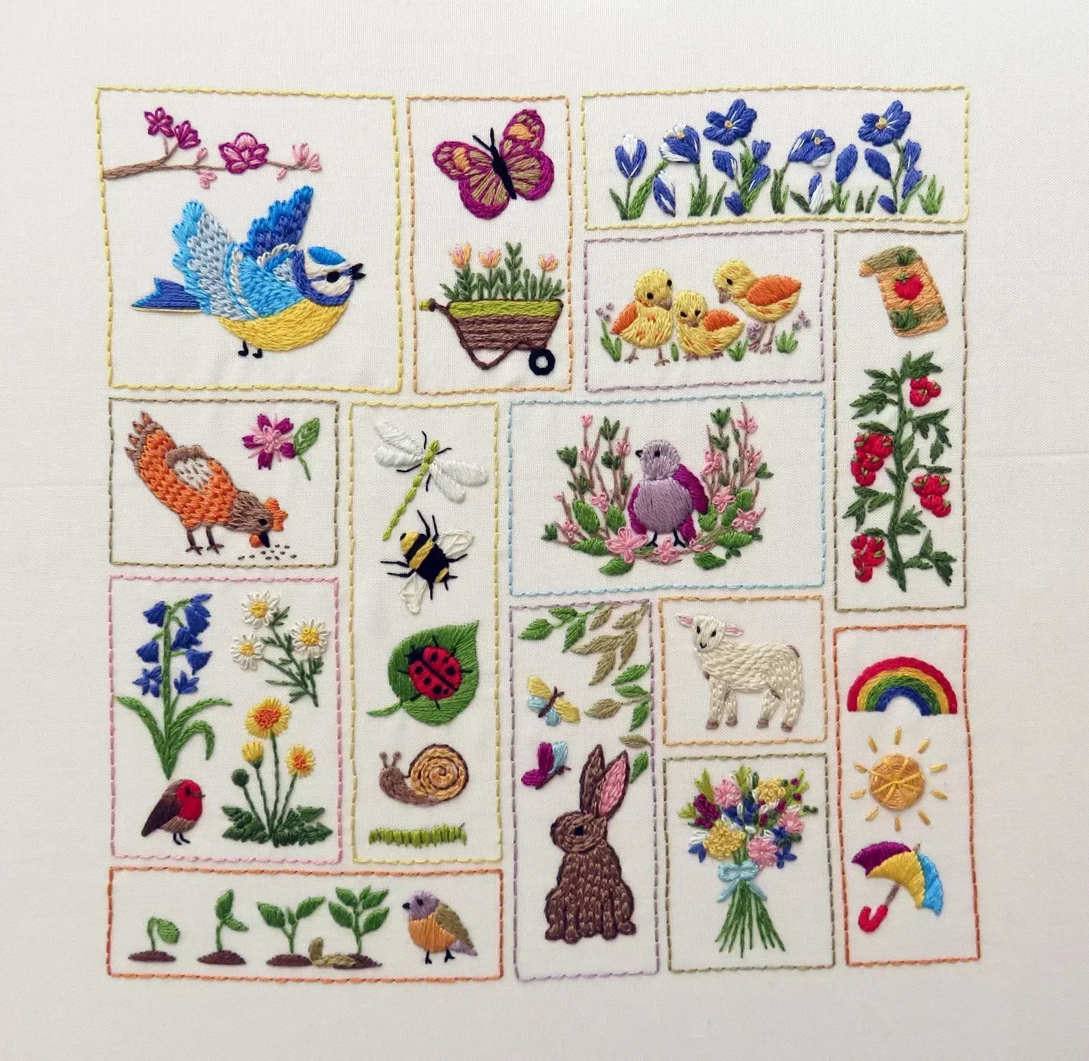 Embroidered patchwork with various nature-themed designs on a white background