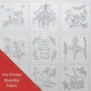Pre-printed fabric with various designs including birds, plants, and a milk bottle on a white background.