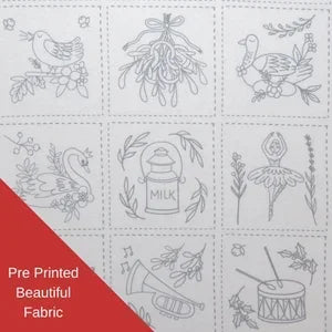 Pre-printed fabric with various designs including birds, plants, and a milk bottle on a white background.