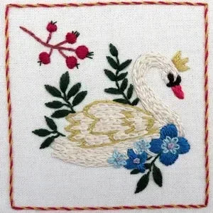 Embroidered swan with flowers and leaves on a white background