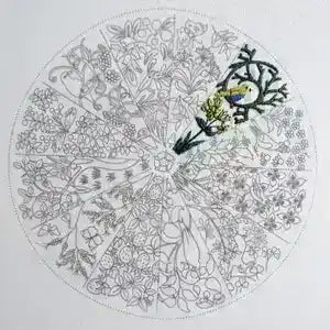 Coloring page with a mandala design featuring a bird and floral elements, partially colored.