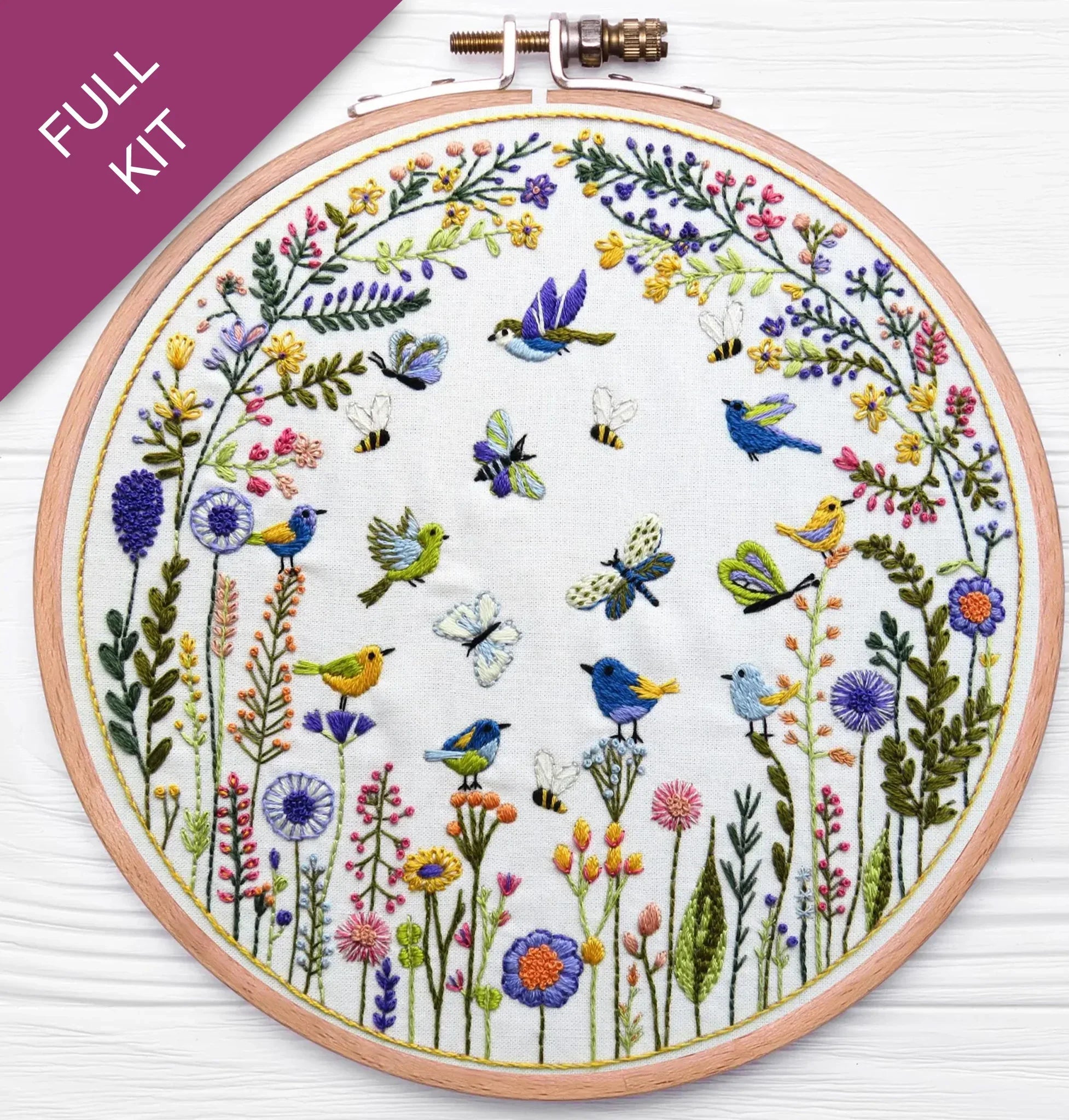 Embroidery hoop with floral and bird design on a white background