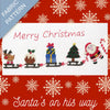 Fabric pattern with Christmas-themed design featuring Santa, reindeer, and snowflakes on a red background.