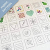 Collection of embroidered patterns on fabric with various designs including birds, flowers, and geometric shapes.