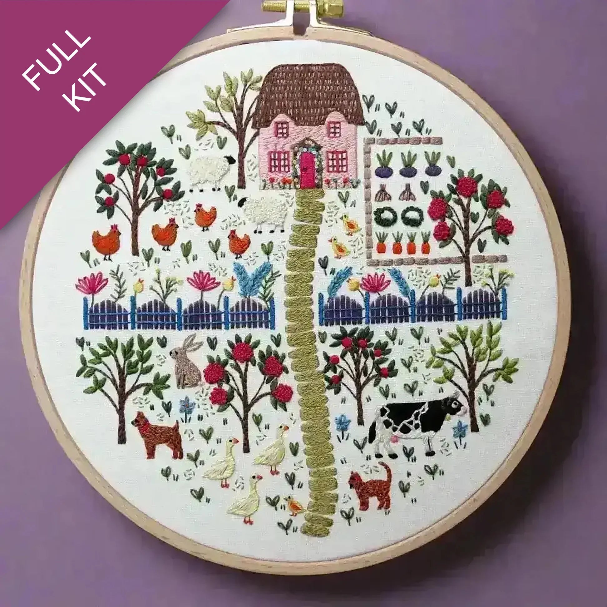 Embroidery hoop with a colorful garden scene on a purple background