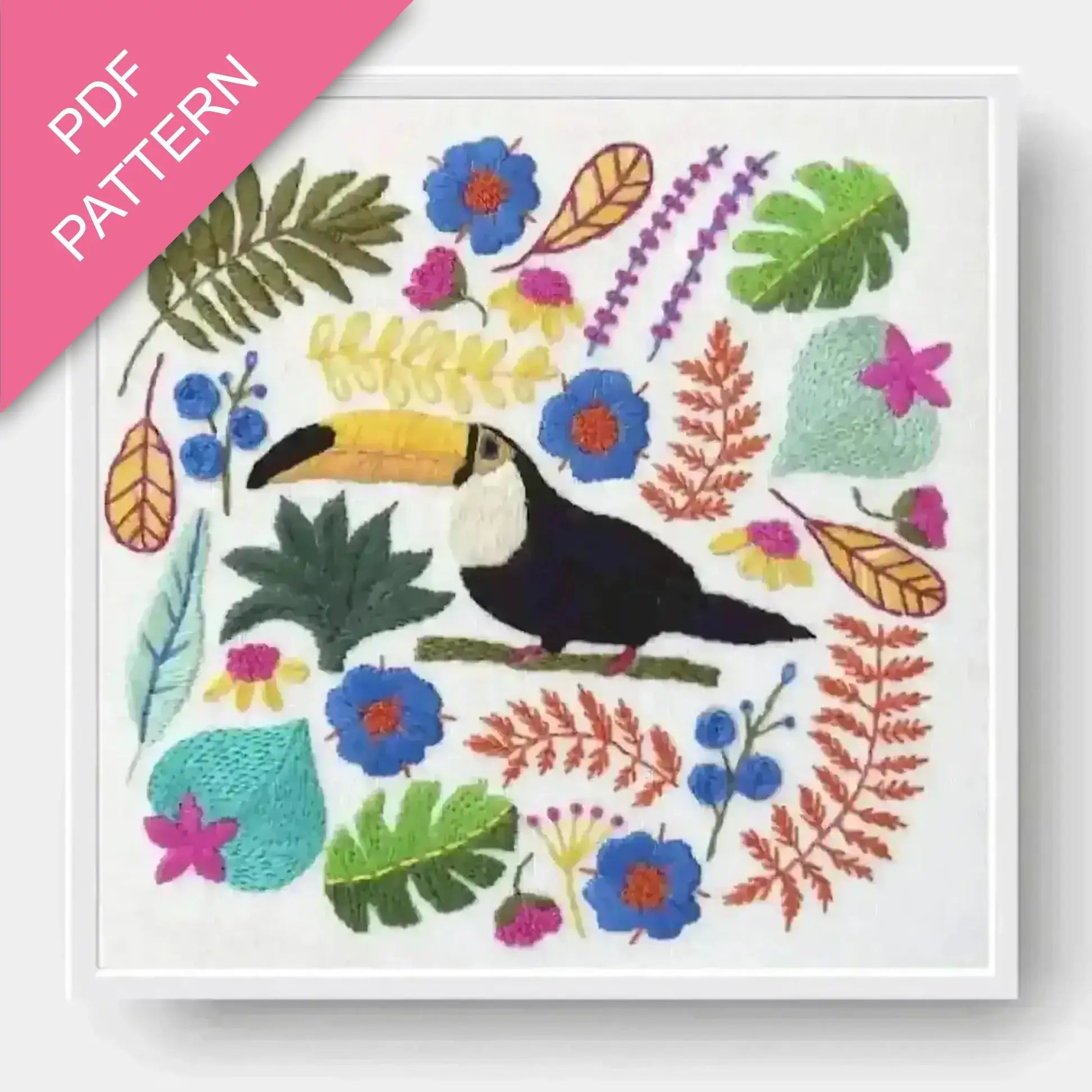 Colorful embroidery pattern with a toucan and tropical leaves on a white background