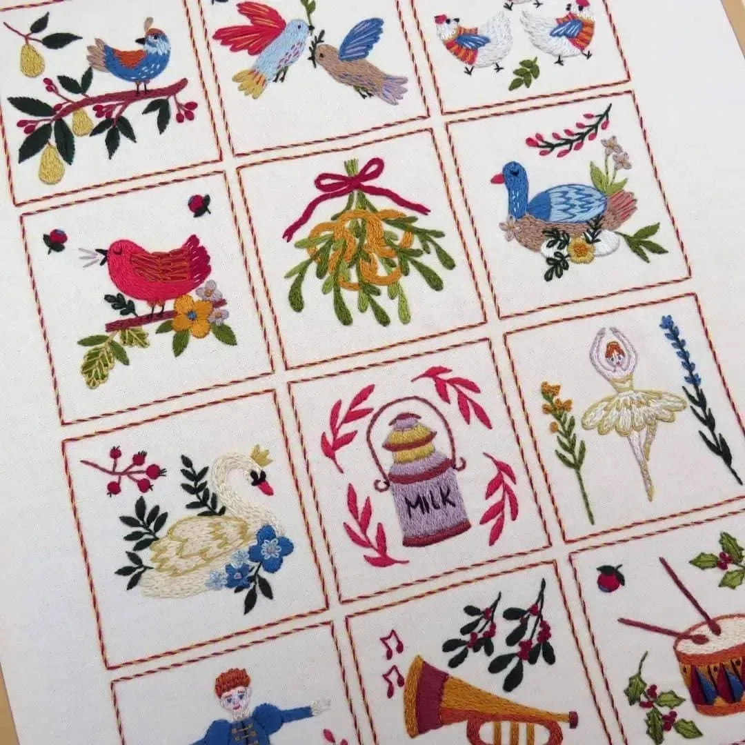Collection of embroidered designs featuring birds, flowers, and other elements on a white background.