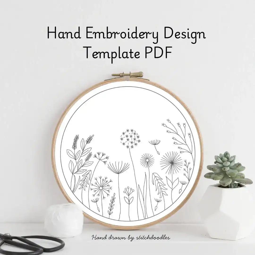 Hand embroidery design template with floral patterns in an embroidery hoop on a white background.
