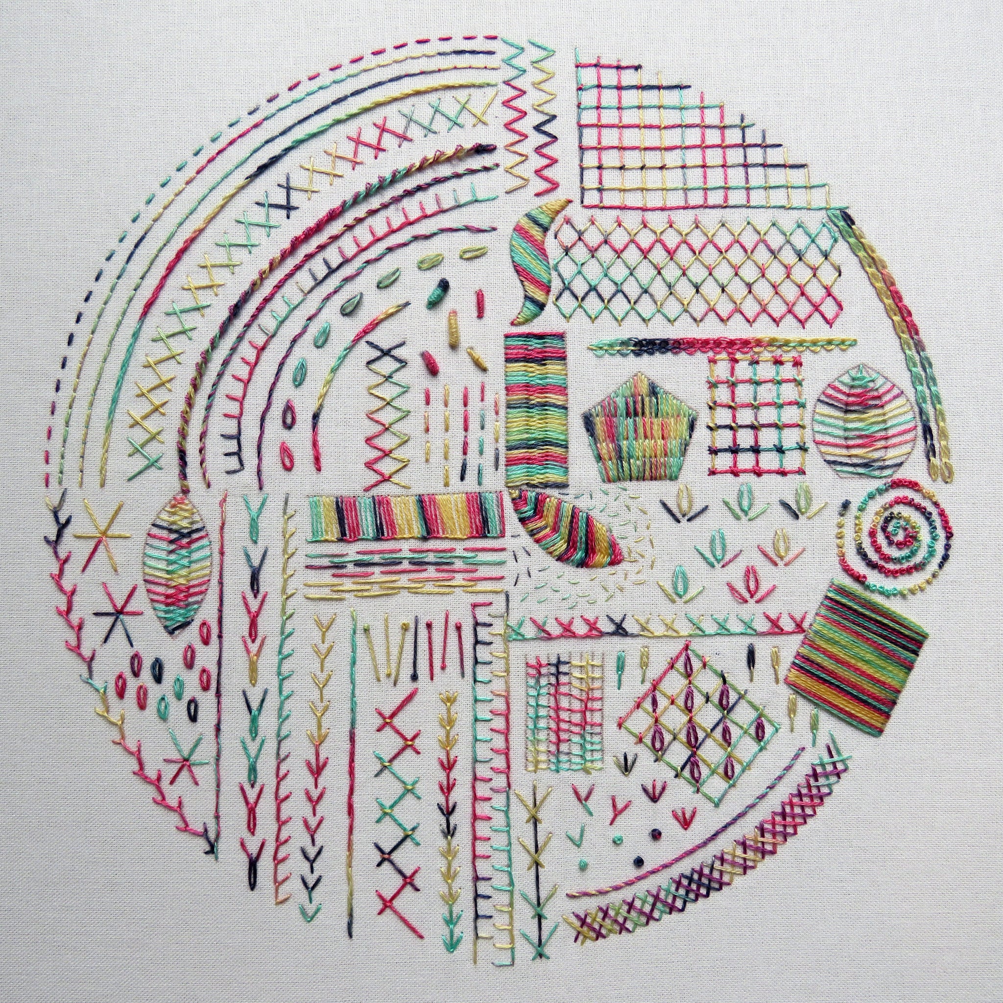 Embroidery design with colorful stitches on a white background