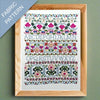 Framed fabric pattern with embroidered letters and designs on a green background