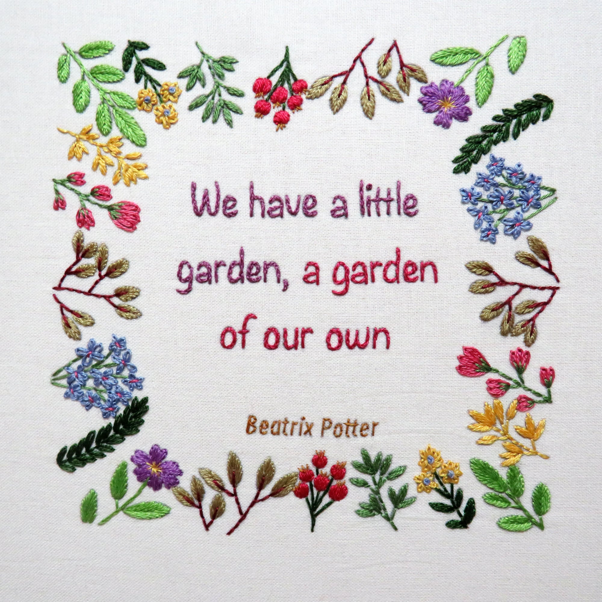 Embroidered quote with floral border and Beatrix Potter's text on a white background