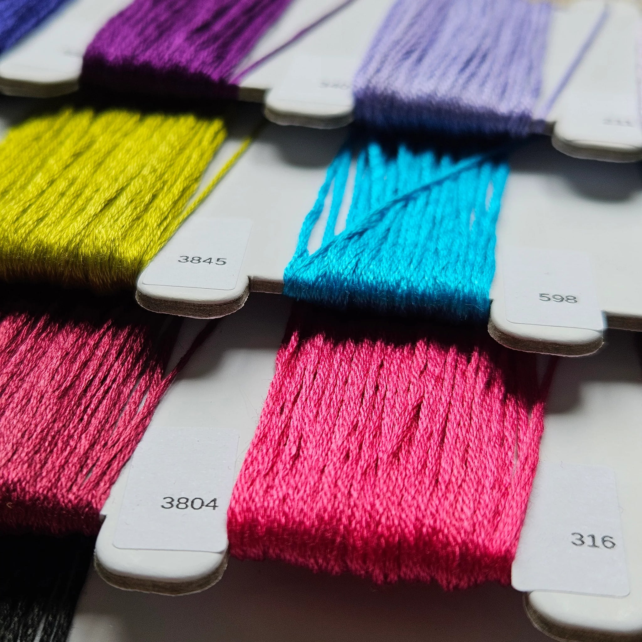 Color swatches with various yarn colors on a white background