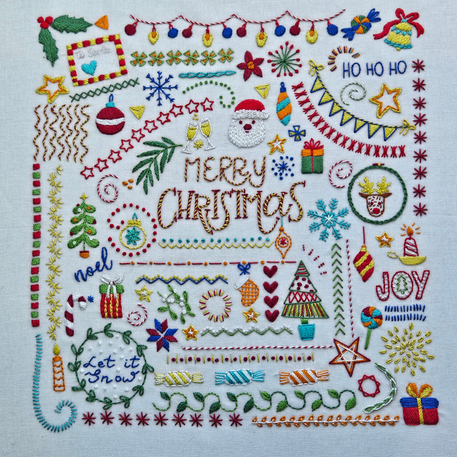 Embroidered Christmas design with various festive elements on a white background